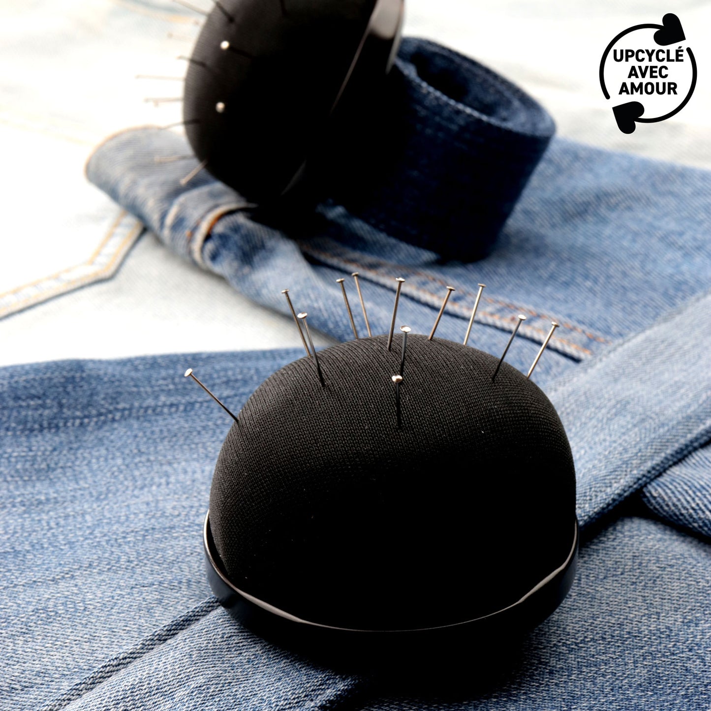 Black pincushion with upcycled denim clap bracelet