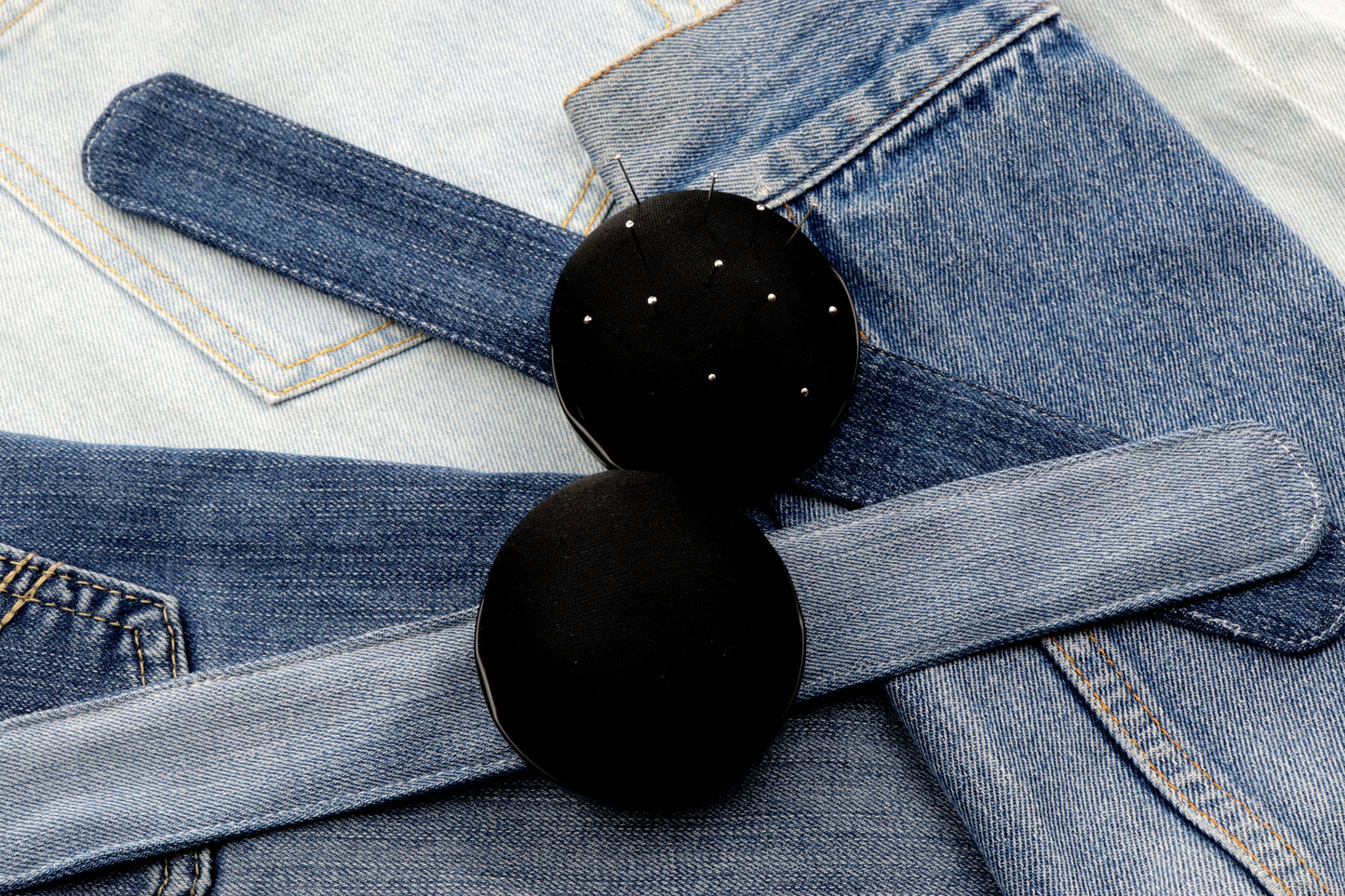 Black pincushion with upcycled denim clap bracelet